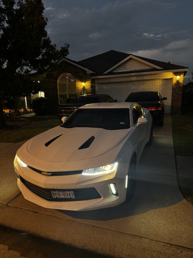 White Chevy Camaro parked outside after exterior wash and paint enhancement