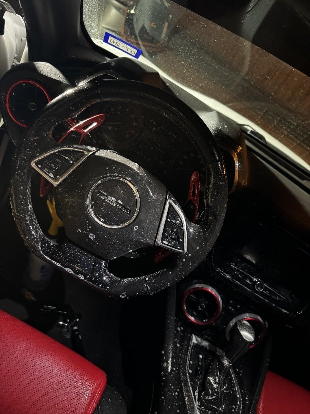 Chevy Camaro leather steering wheel covered in foam during interior deep clean