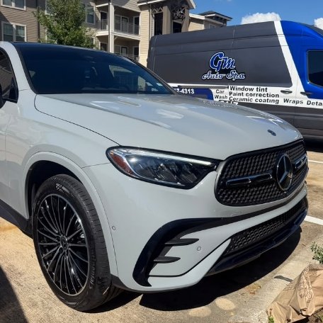 Grey Mercedes Benz SUV detailed next to GM Auto Spa mobile van