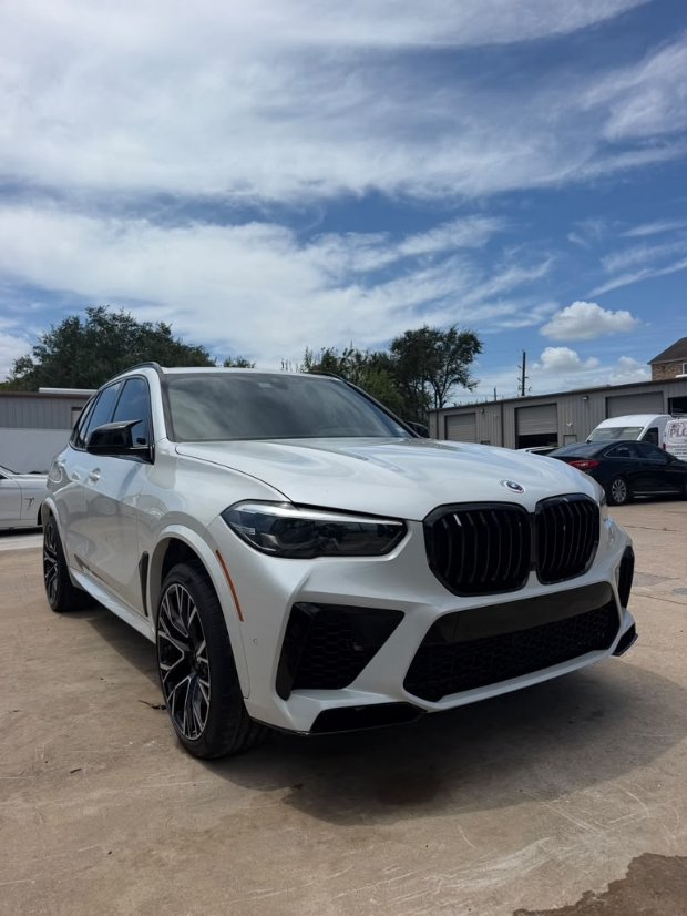 White BMW X5 SUV with glossy ceramic coating finish parked outside